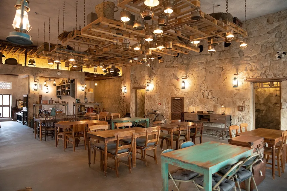 The Al Fanar dining room at Al Barsha, with lanterns over wooden tables